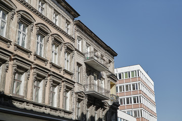 Fototapeta na wymiar A facade of an Art Nouveau townhouse next to a modernist building in Poznan.
