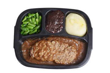 isolated salisbury steak tv dinner with brownie