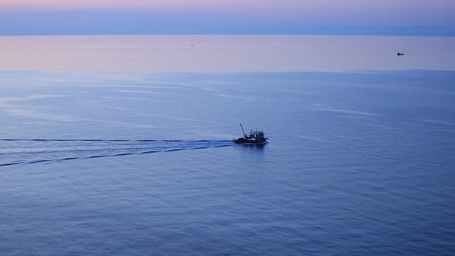 shrimp trawler fishing in sunset