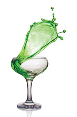 Splash in glass of a green alcoholic cocktail drink