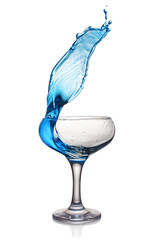 Splash in glass of a blue alcoholic cocktail drink