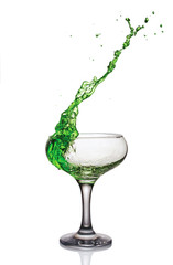 Splash in glass of a green alcoholic cocktail drink
