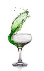 Splash in glass of a green alcoholic cocktail drink