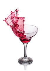 Splash in glass of a pink alcoholic cocktail drink