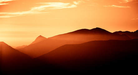 A beautiful, colorful, abstract mountain landscape in a red tonality. Decorative, artistic look.