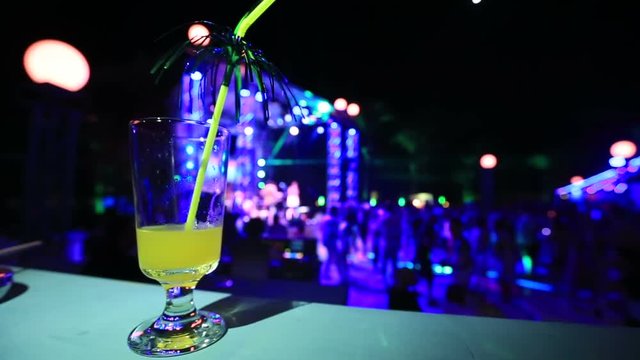 colourfull night club background with coktail glass