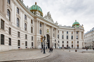 Fototapeta premium Cloudy view of Hofburg Palace at Michaelerplatz, Habsburg Empire landmark in Vienna, Austria.