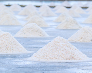 Salt production from sea water evaporation called Naklua Mass at salt farm in Petchaburi province of Thailand