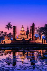 Naklejka premium Buddha with twilight at Sukhothai historical park, the old town of Thailand