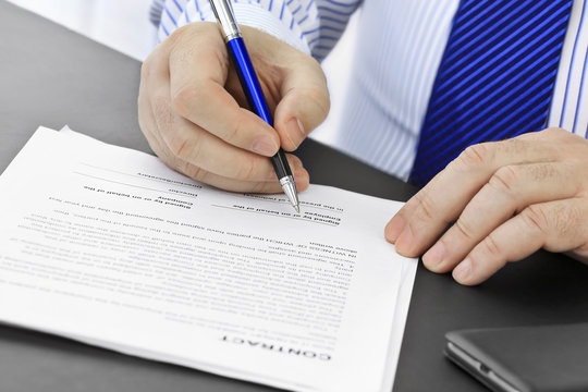 Businessman with pen  signing a contract