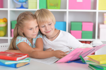 Fototapeta premium Girl and boy doing lessons