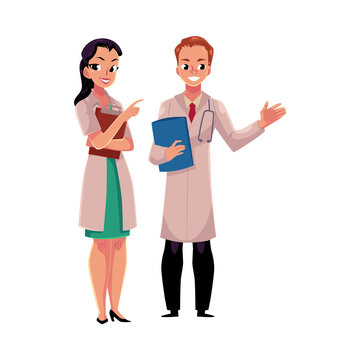 Male and female doctors in white medical coats, woman pointing to man with stethoscope, cartoon vector illustration isolated on white background. Full length portrait of two doctors with clipboards