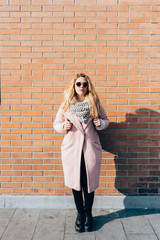 Young beautiful caucasian blonde hair woman posing outdoor in the city, pensive - serious, thoughtful, melancholic concept