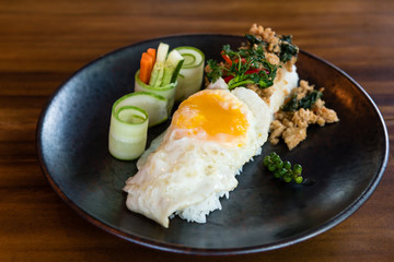 thai style stir fried minced chicken with sweet basil over rice 