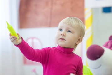 Adorable little girl with pen