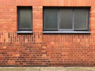 Windows and beautiful rough Brick wall facade