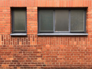 Windows and beautiful rough Brick wall facade
