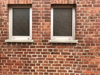 Windows and beautiful rough Brick wall facade
