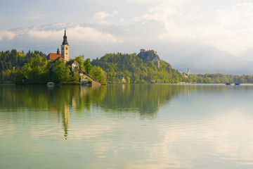 Bled lake and pilgrimage church with spring mountain landscape background