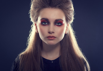 Fashionable photo. Beautiful young woman in a stylish hair and bright makeup.