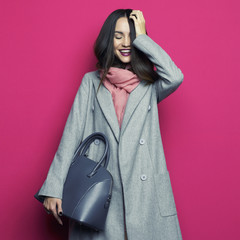 Young stylish woman in grey coat