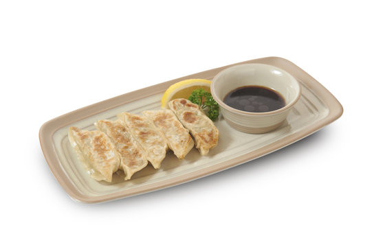 Isolated and clipping path of Japanese gyoza with soy sauce.