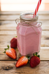 Strawberry smoothie on wooden background