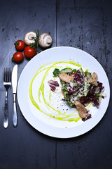 cooked fish with fresh salad leaves, mushroom and cherry tomato