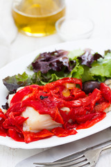 cod fish with pepper and salad on white dish
