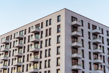 Corner of grey building with balconies