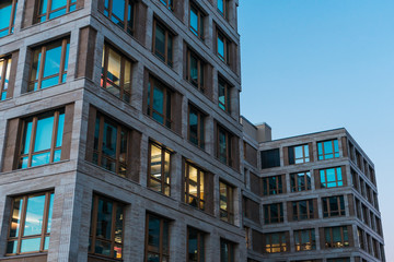 Lights glowing in an office block at twilight
