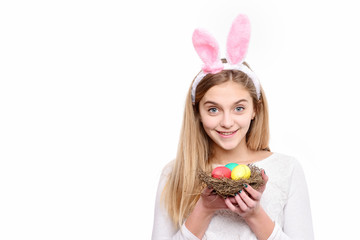 happy easter girl in bunny ears with colorful painted eggs