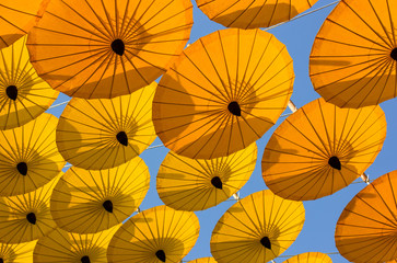 Fototapeta na wymiar many decoration with hanging yellow umbrella outdoor