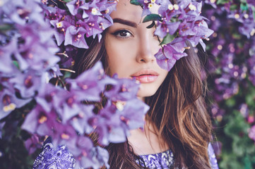 Beautiful young woman surrounded by flowers - 142495008