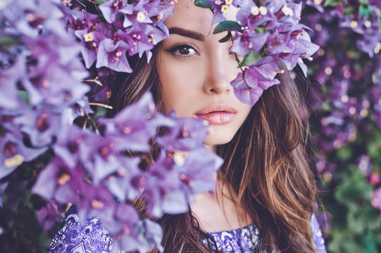 Beautiful Young Woman Surrounded By Flowers