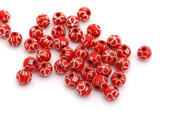 Decorative red beads scattered on white background - accessories for handmade and hobby