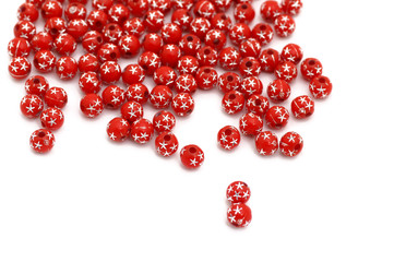 Decorative red beads scattered on white background - accessories for handmade and hobby