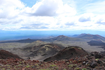 Black and red ash, valley of hills, after volcanic eruption