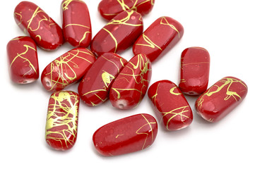 Decorative red beads scattered on white background - accessories for handmade and hobby