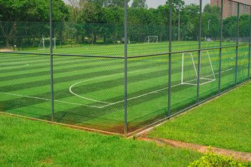 a soccer field behind the fence