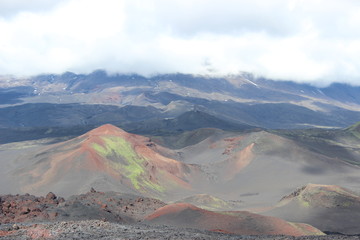 Black and red ash, valley of hills, after volcanic eruption