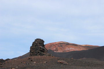 Black and red ash, valley of hills, after volcanic eruption