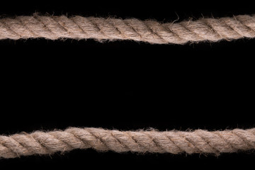 Thick rope on a black background. Sea rope