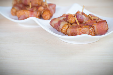 Deep fried sausages rolled in bacon
