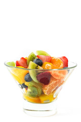Fruit salad in crystal bowl isolated on white background
