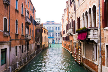 Fototapeta na wymiar Water canal and venetian buildings in its typical architecture in Venice, Italy.