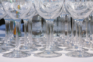 Empty wine glasses in row on restaurant table