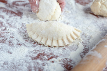 Mother preparing Vareniki - dumplings with cottage and cheese