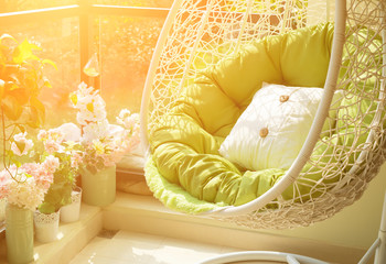 garden swing with mattress and cushion in a balcony in the morning