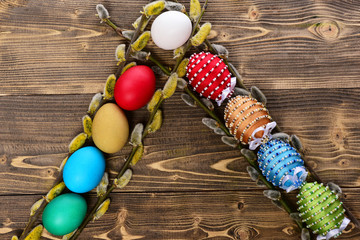 easter colorful eggs decorated with thread, beads with willow, osier